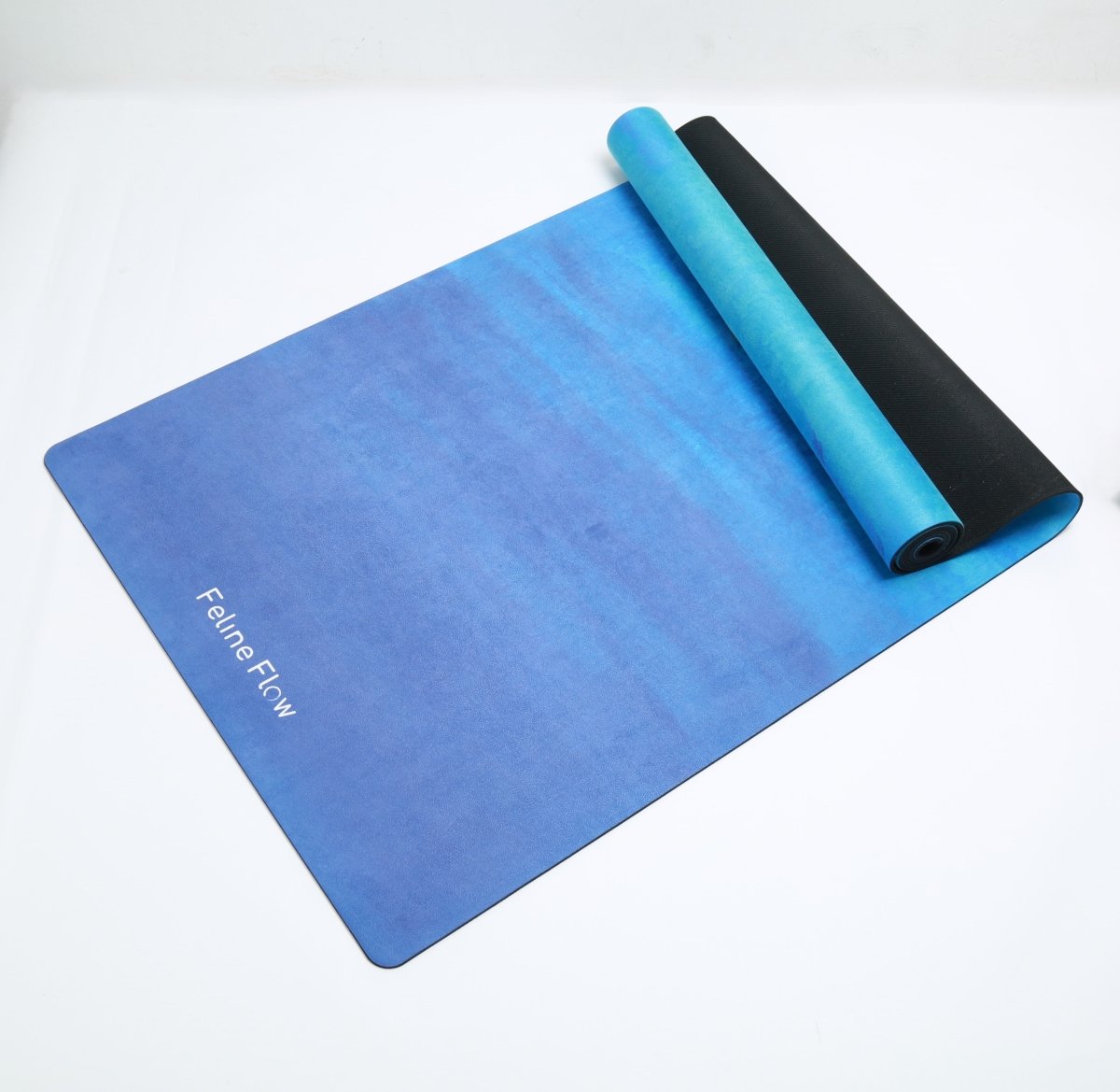 Blue yoga mat half rolled on white background