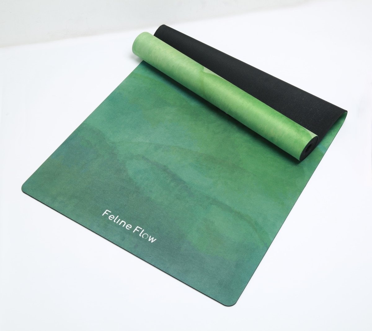 Green yoga mat half rolled on white background