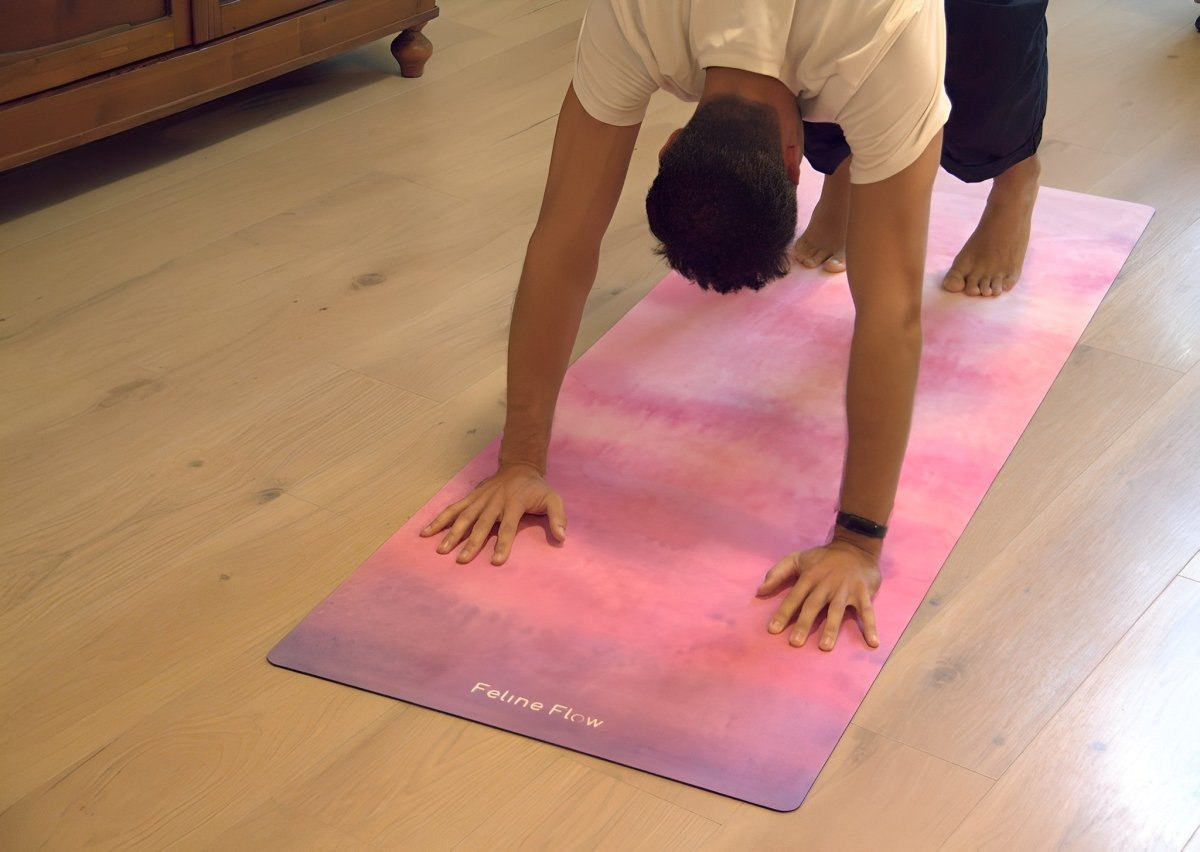male stretching on fuchsia yoga mat in a living room with wooden floors