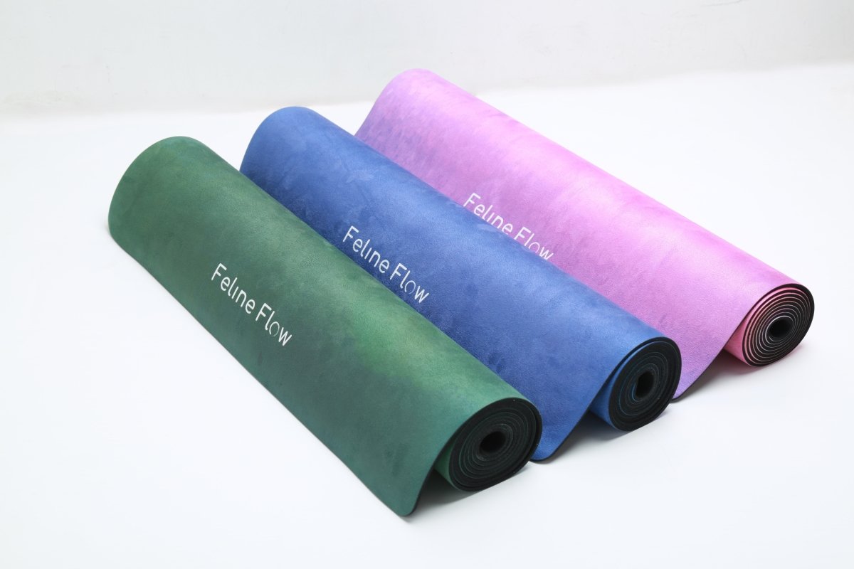 Rolled yoga mats green blue pink Feline Flow brand white background