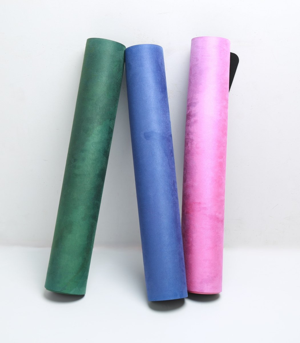 Vertical rolled yoga mats green blue pink Feline Flow white background