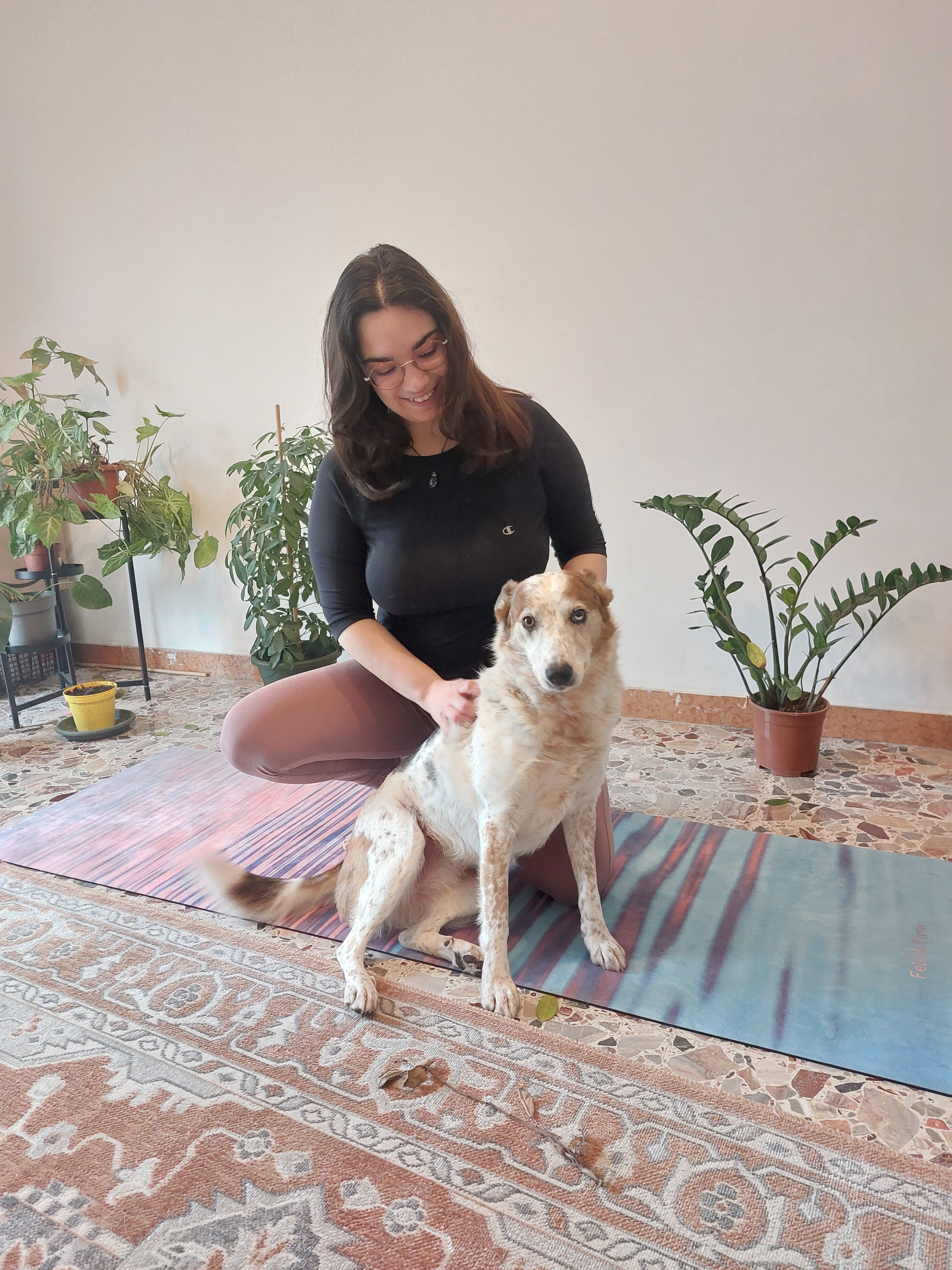 woman and dog on Feline Flow yoga mat living room indoor plants